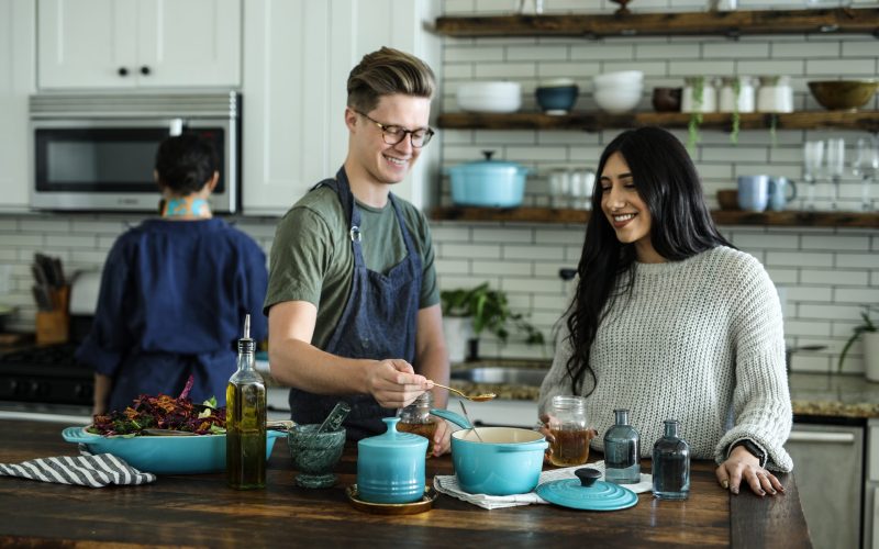 Friends cooking together in kitchen